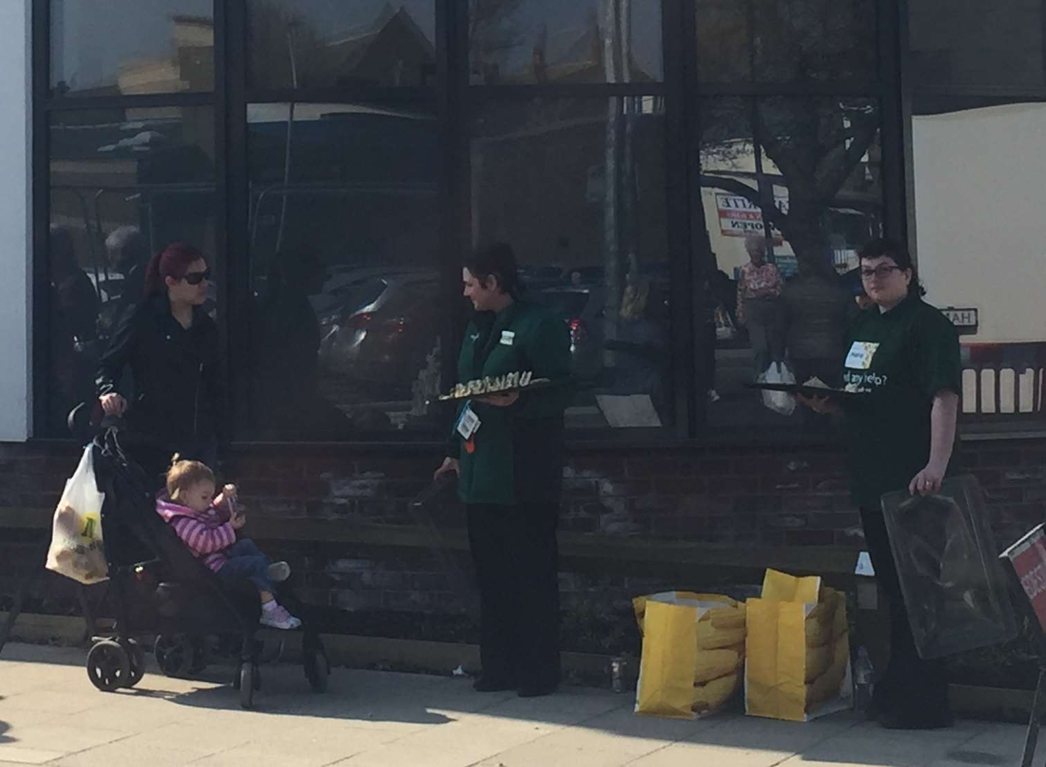 Morrisons staff giving out sandwiches outside the new Aldi store