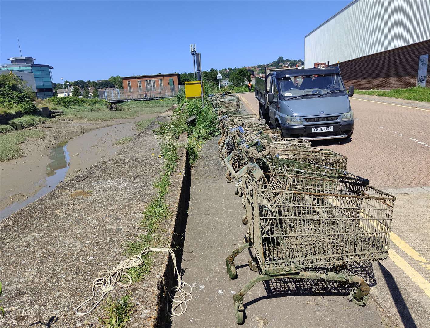 Trolleys lined up by the creek