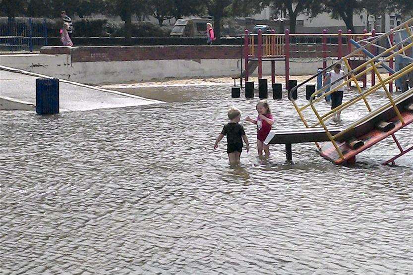 Thomas and Daisy Wale splash about in the flooded Sheerness sandpit