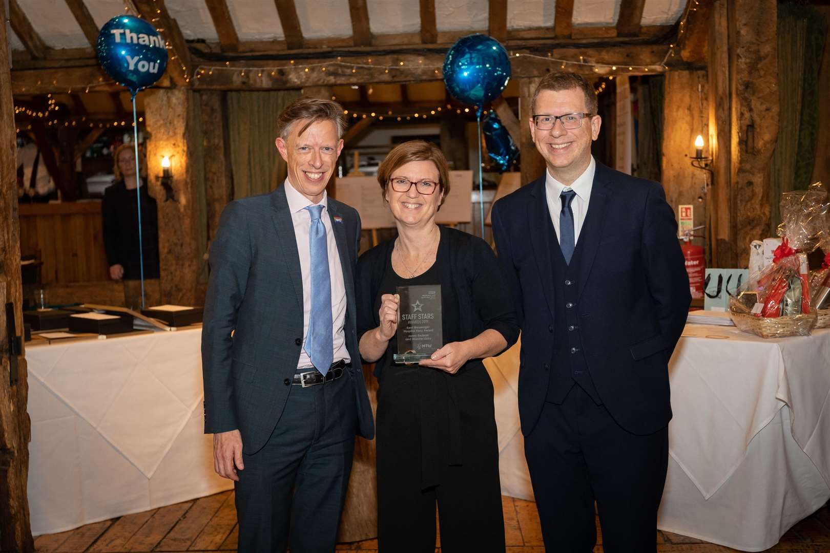 Maxine Libby, accepted the Maidstone Hospital Hero award for herself and on behalf of Jenny Endean. Pictured with CEO Miles Scott, left, and Paul Kerensa, comedian, right, who helped host the event
