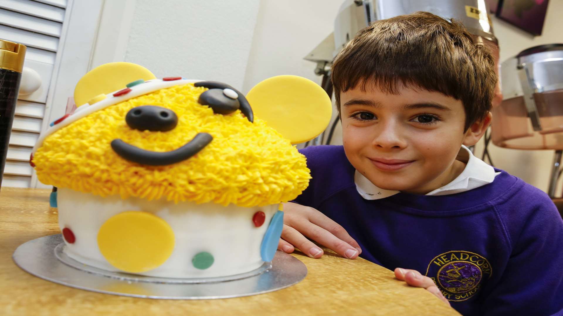 Nathan Coppin with a Pudsey cake at Cut Above in Headcorn. Picture: Martin Apps