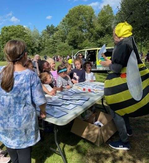 Director of Housing, Brian Cooke dressed as a bee, takes children on a bug hunting masterclass