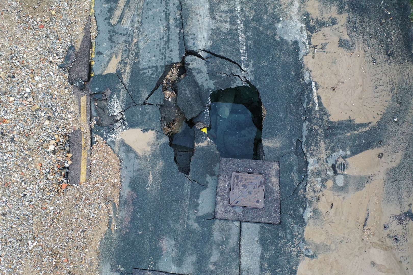 The sinkhole open in Priory Road due to a burst water main. Images: UKNIP