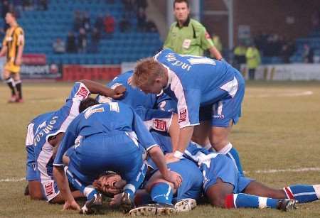OVERJOYED: Neil Harris is mobbed by his team-mates after scoing Gillingham's opener against Port Vale. Picture: GRANT FALVEY