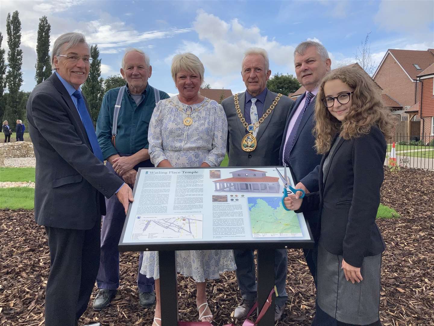 Pupil Ellie Wolfe, 12, right, cut the ribbon to unveil the recreation of the 2,000-year-old Romano-British temple discovered near her home at Newington, Sittingbourne, with, from the left, Richard Thompstone, Paul Wilkinson, the mayor and mayoress of Swale Cllrs Paul and Sarah Stephen and Martin Crick of Persimmon Homes