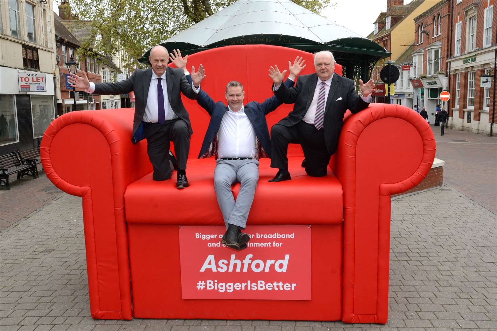 Ashford MP Damian Green, Virgin Media director Neil Bartholomew and council leader Gerry Clarkson sit on the giant red armchair
