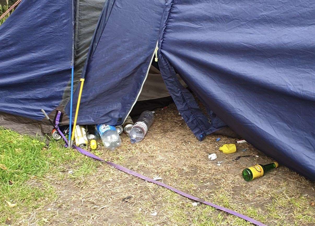 Bottles and littler spilling out of one of the squatters' tent in St George's churchyard in Ramsgate