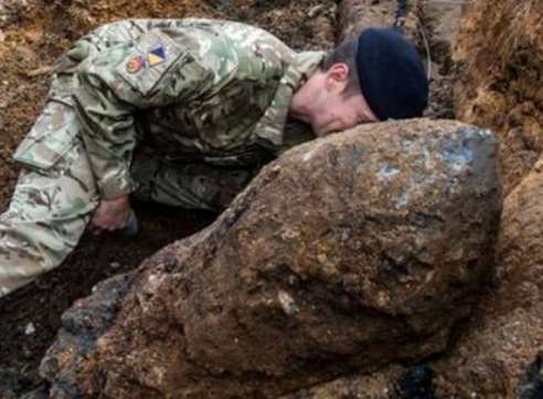 An army bomb disposal expert next to the large device. Stock image
