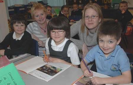 RAISING STANDARDS: Teaching assistant Kim Stewart and teacher Lisa Taylor with pupils. Pictures: BARRY CRAYFORD