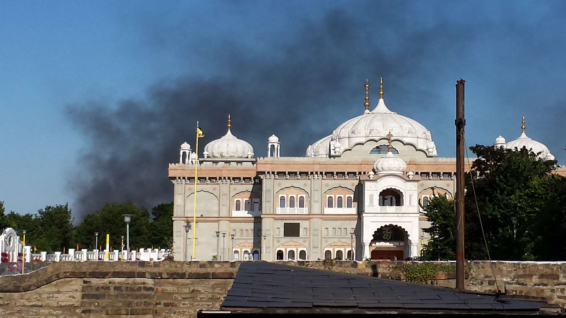 Smoke could be seen billowing up from beyond the gurdwara