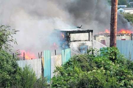 Flames shoot from the burning buildings at the height of the blaze. Picture: Peter Still