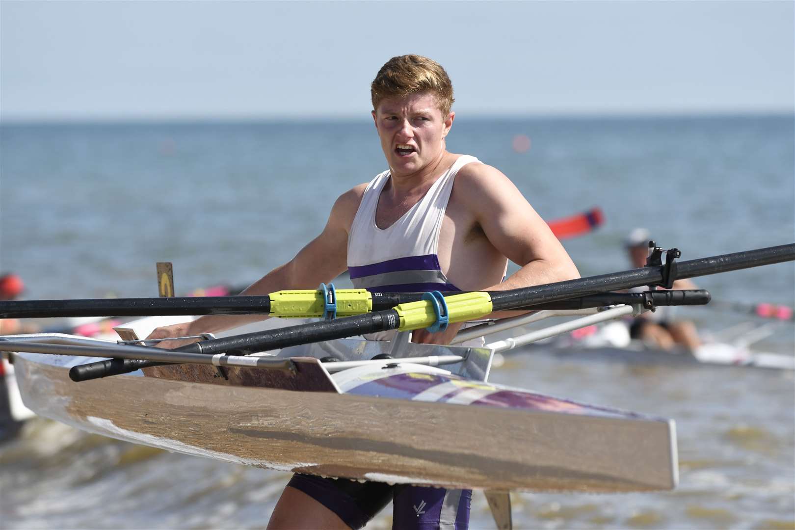 Will Dennis carries his boat to the water ahead of a Men's Senior Sculls race Picture: Tony Flashman