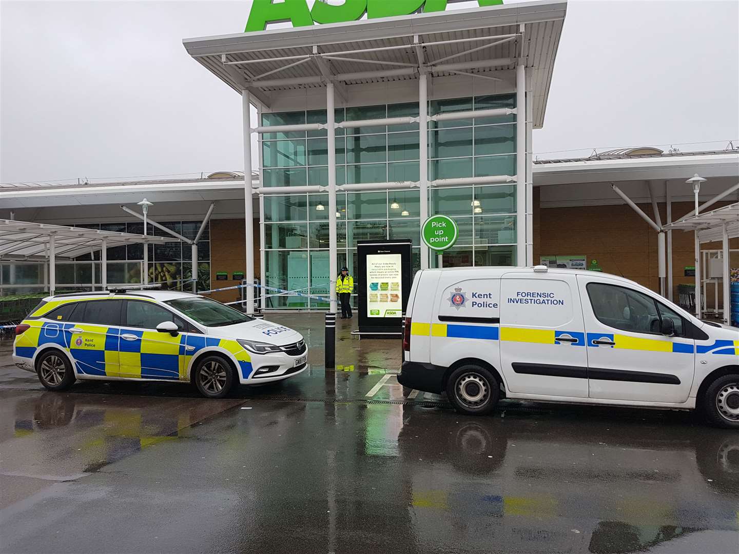 Police vehicles parked outside Asda in Ashford this morning