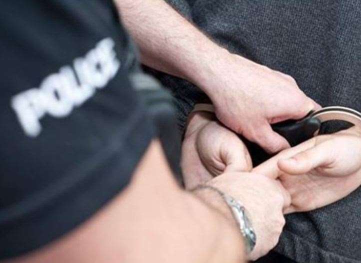 A police officer making an arrest - stock image