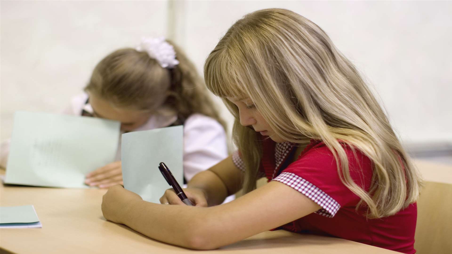 Pupils taking a test. Stock image.