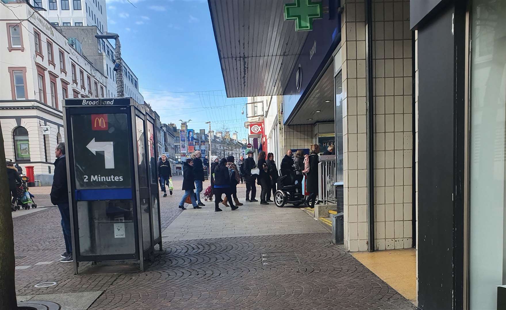Shoppers queue outside Boots in Folkestone as panic buying sweeps the nation