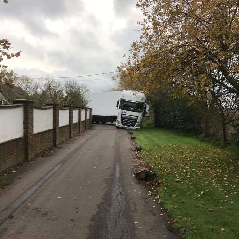 A lorry trying to navigate a narrow road