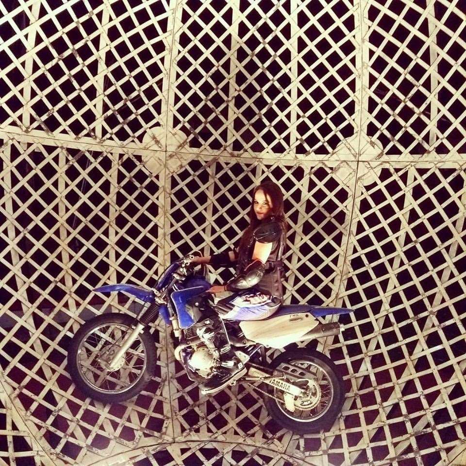 Drueicy Madorf in the metal cage which three motorcyclists ride around in the stunt