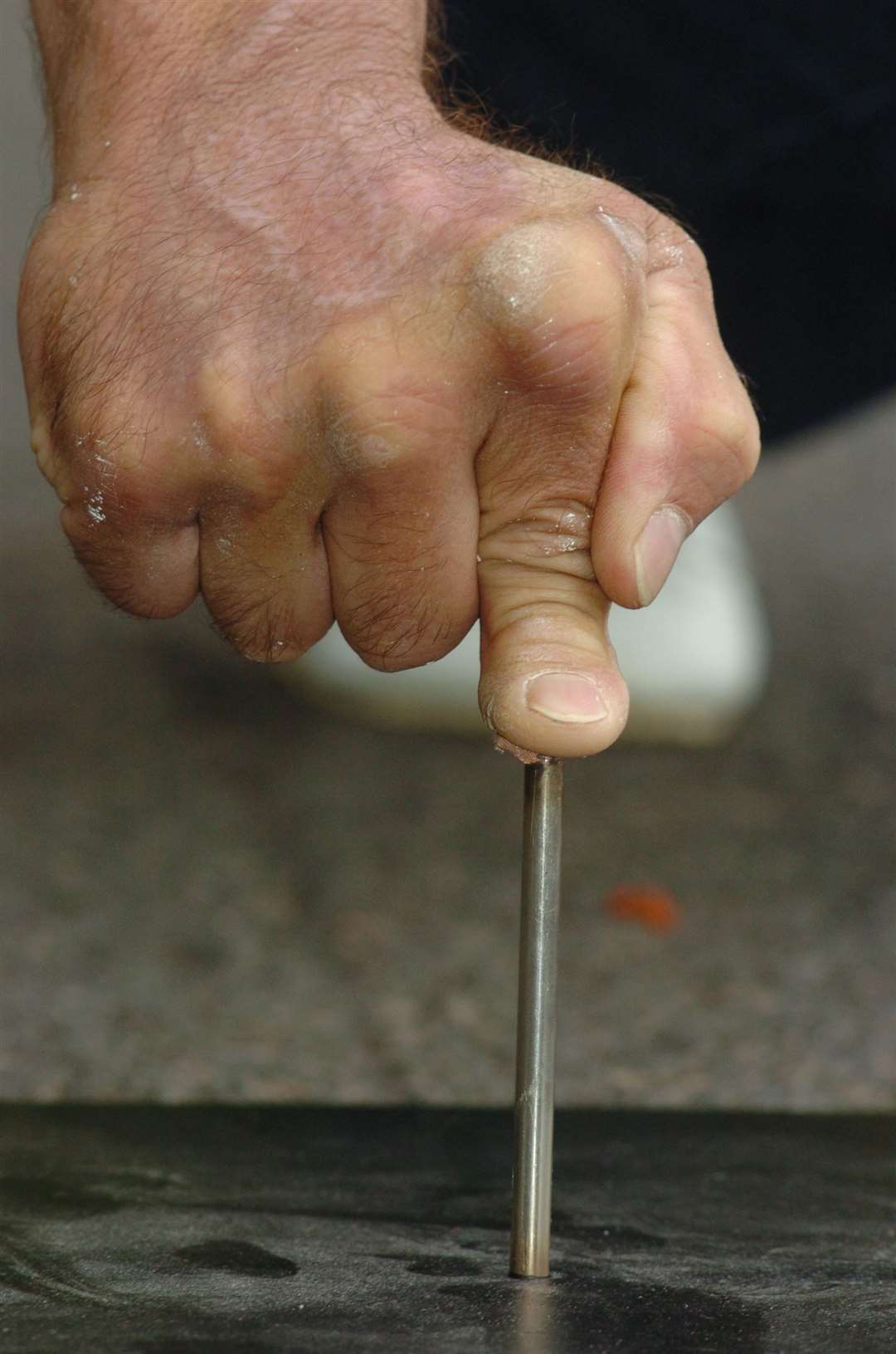 Mick Gooch does his one-finger push-ups balancing on a nail. Pic: Grant Falvey