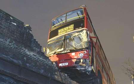 ON THE BRINK: The No 432 bus on the edge of the railway bridge. Picture: METROPOLITAN POLICE