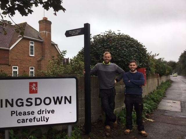 Contractors Carl Purkiss and Adam van Patten after installing the first sign at Boundary Road in Kingsdown
