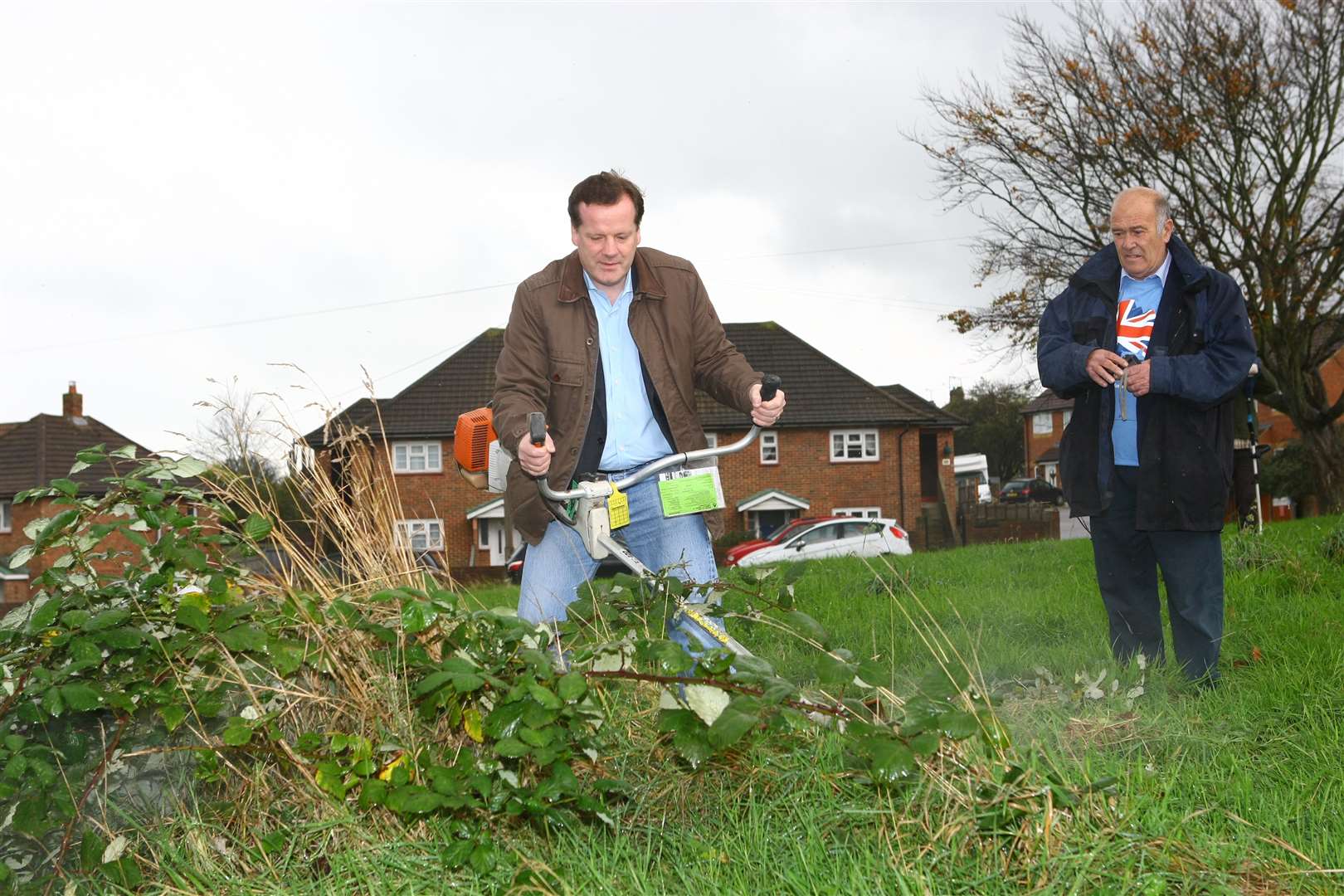 Charlie Elphicke and volunteers cut and clear the grass area in Freemans Way, Deal