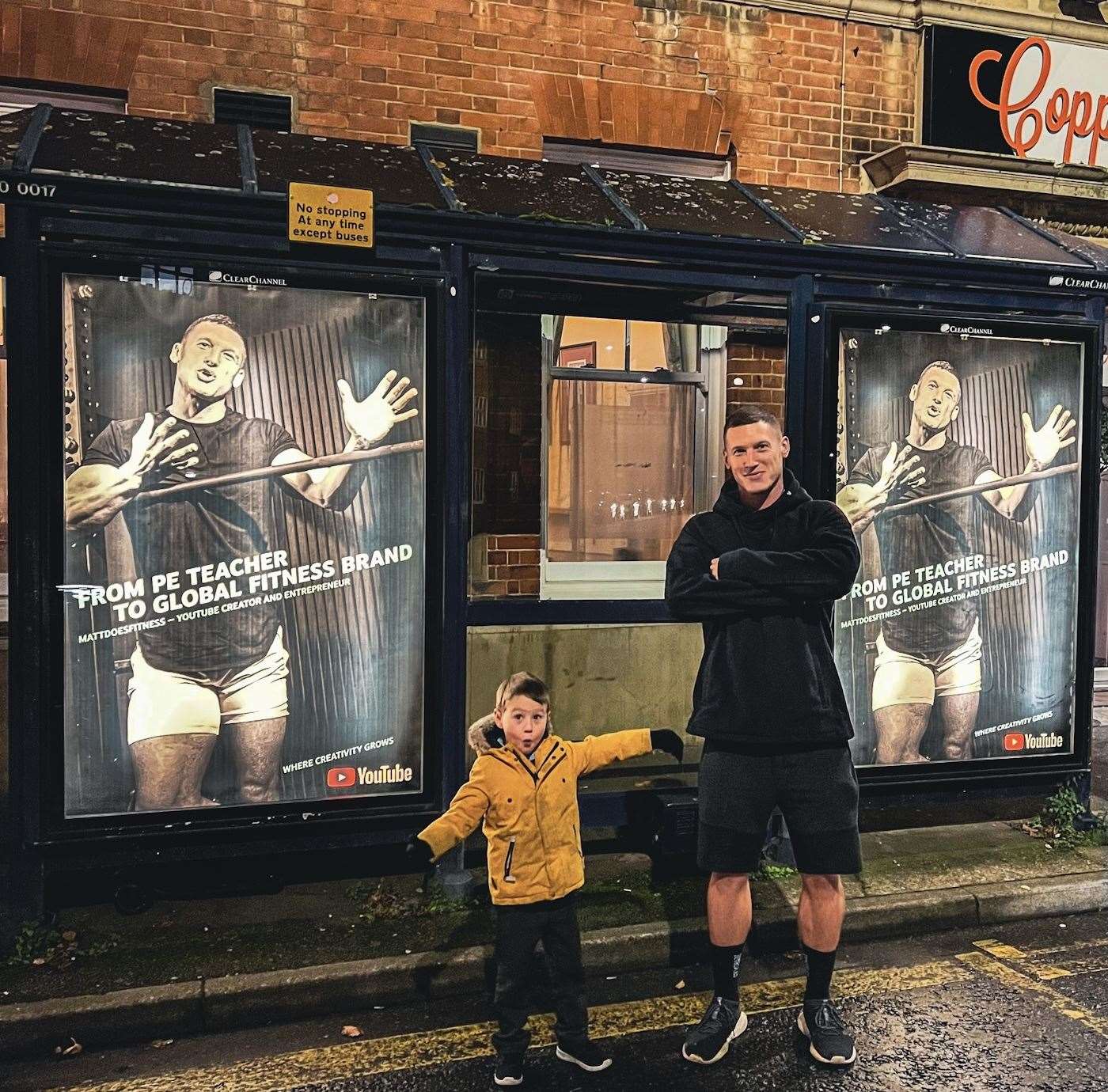 Matt Morsia and his son Luca pose next to a bus stop advertisement about his YouTube hit in Hythe.  Photo: Instagram / Morsia