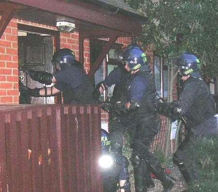 EARLY MORNING CALL: police officers entering one of the addresses