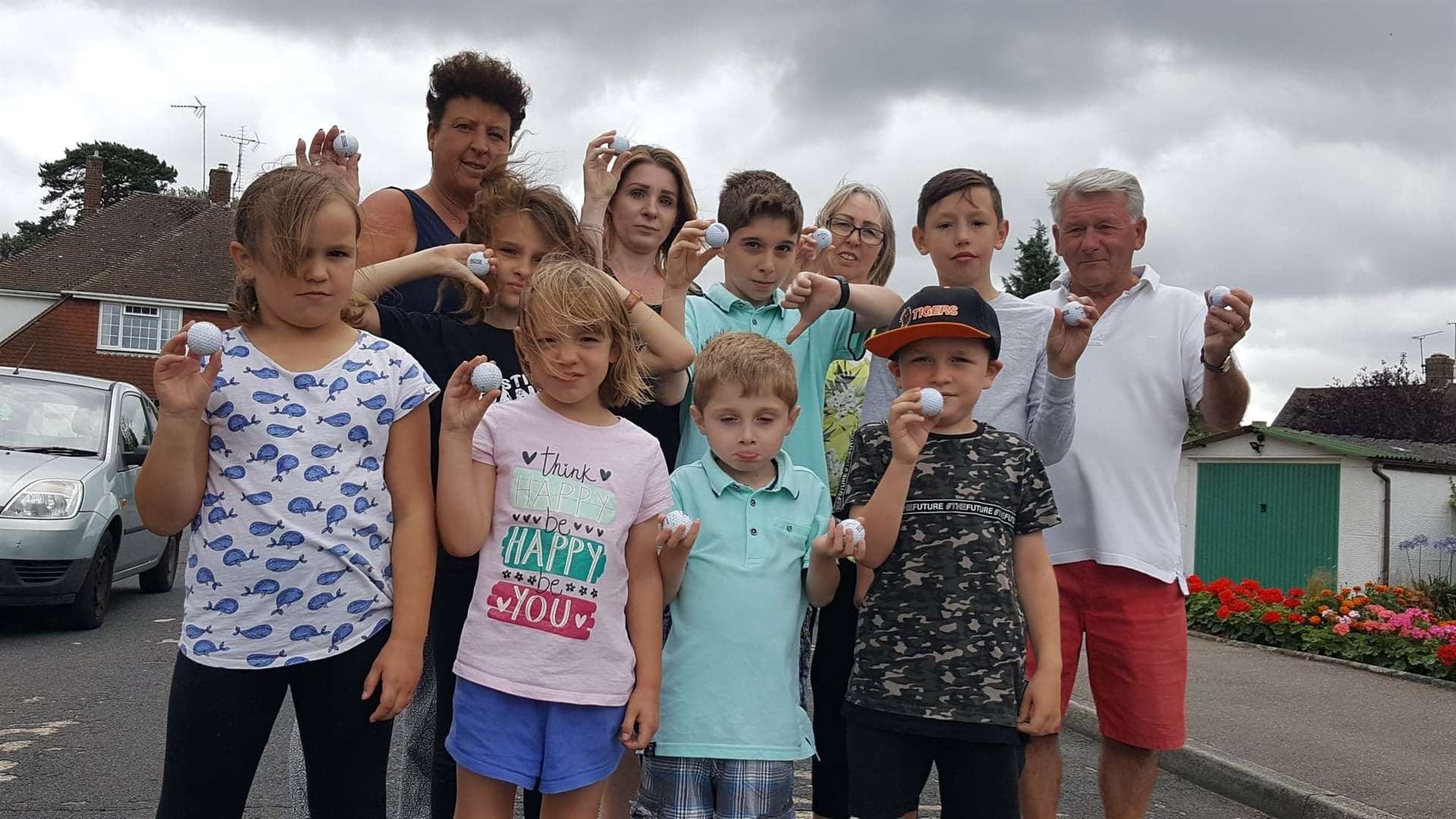 Residents are fed up of the flying golf balls. Back row: Steff Plester, Lynsey Holmewood, Denise Austin and Malcolm Austin with children from the road