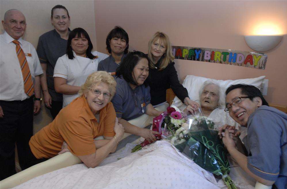 Violet Spence celebrates her 103rd birthday with granddaughter Lynne Herman and some of the staff at the Elvy Court Care Home