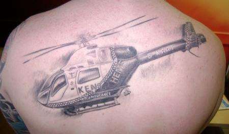 Ex-racing driver Craig Drury shows off his tattoo to thank the Kent Air Ambulance crew who saved his life.