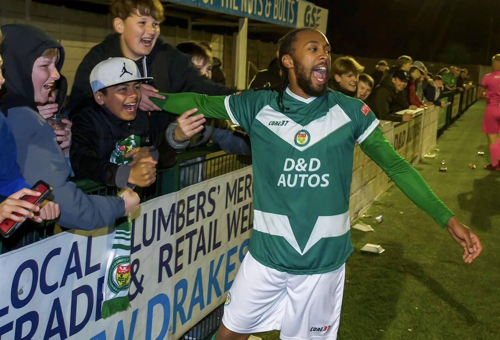 Right-back Bradley Simms celebrates with Ashford fans at full-time Picture: Ian Scammell