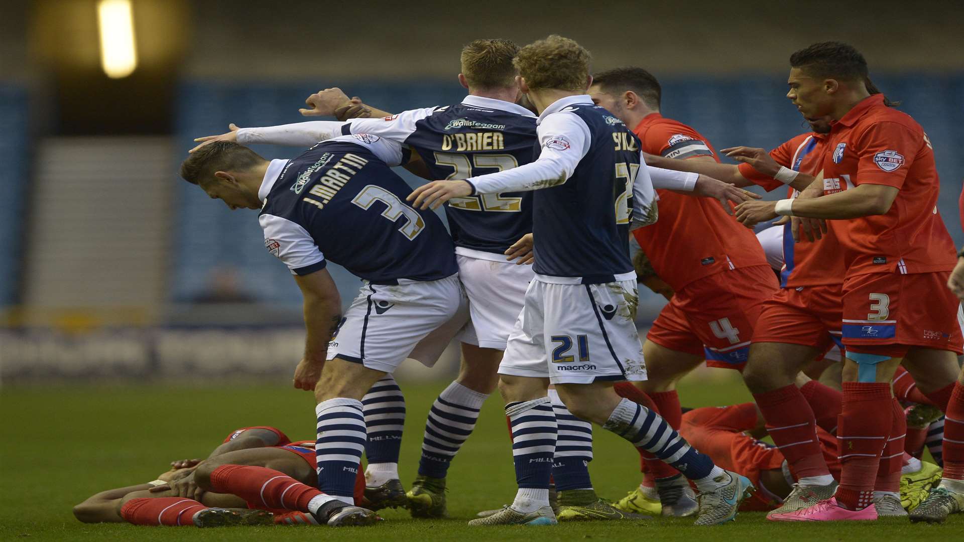 Dominic Samuel goes to ground after a skirmish (behind) following foul on Ryan Jackson