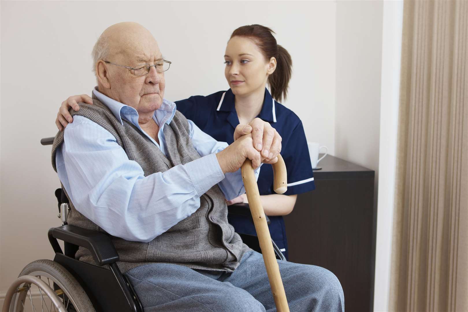 Young nurse hugging senior man in wheelchair. Picture: iStockphoto.