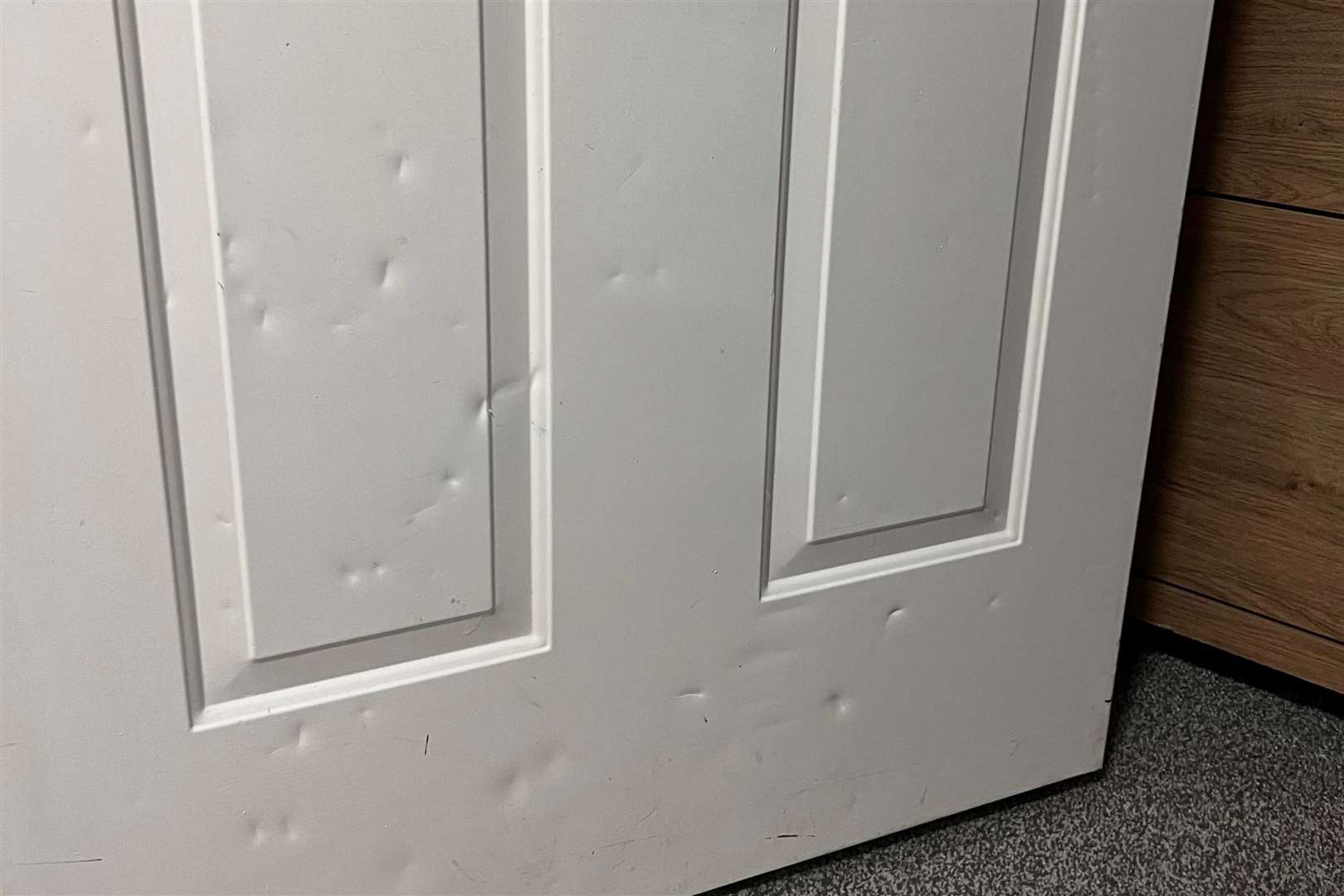 Dents left in the door by the man who tried to break into the flat