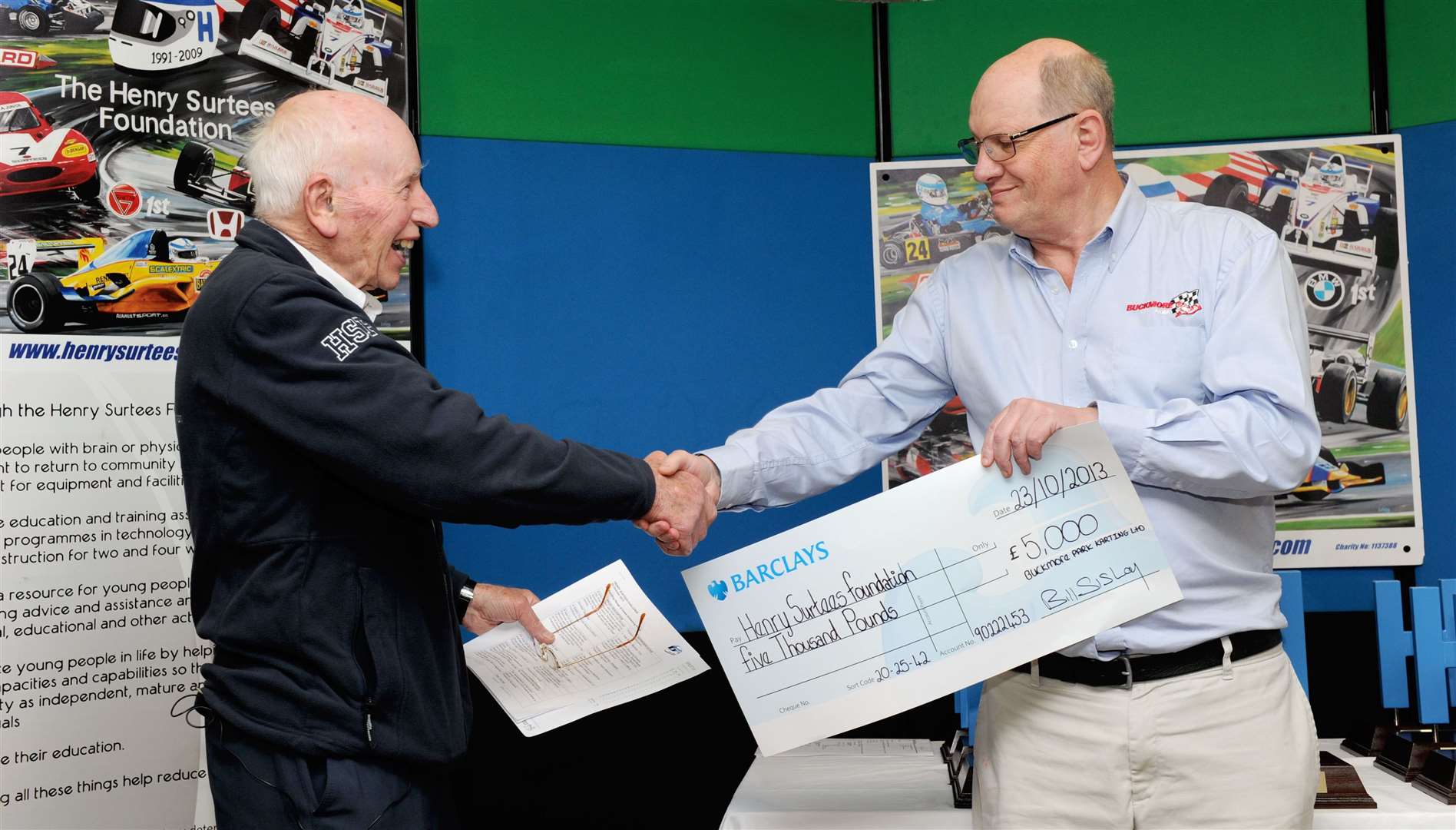 Surtees, who died in March 2017 aged 83, accepts a cheque from Sisley during the Henry Surtees Challenge event in 2013. Picture: Simon Hildrew