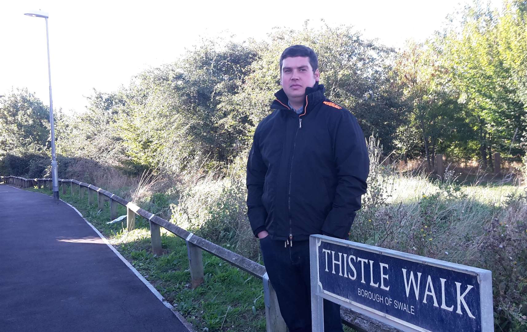 Elliott Jayes with the light he says needs fixing in Thistle Walk, Minster