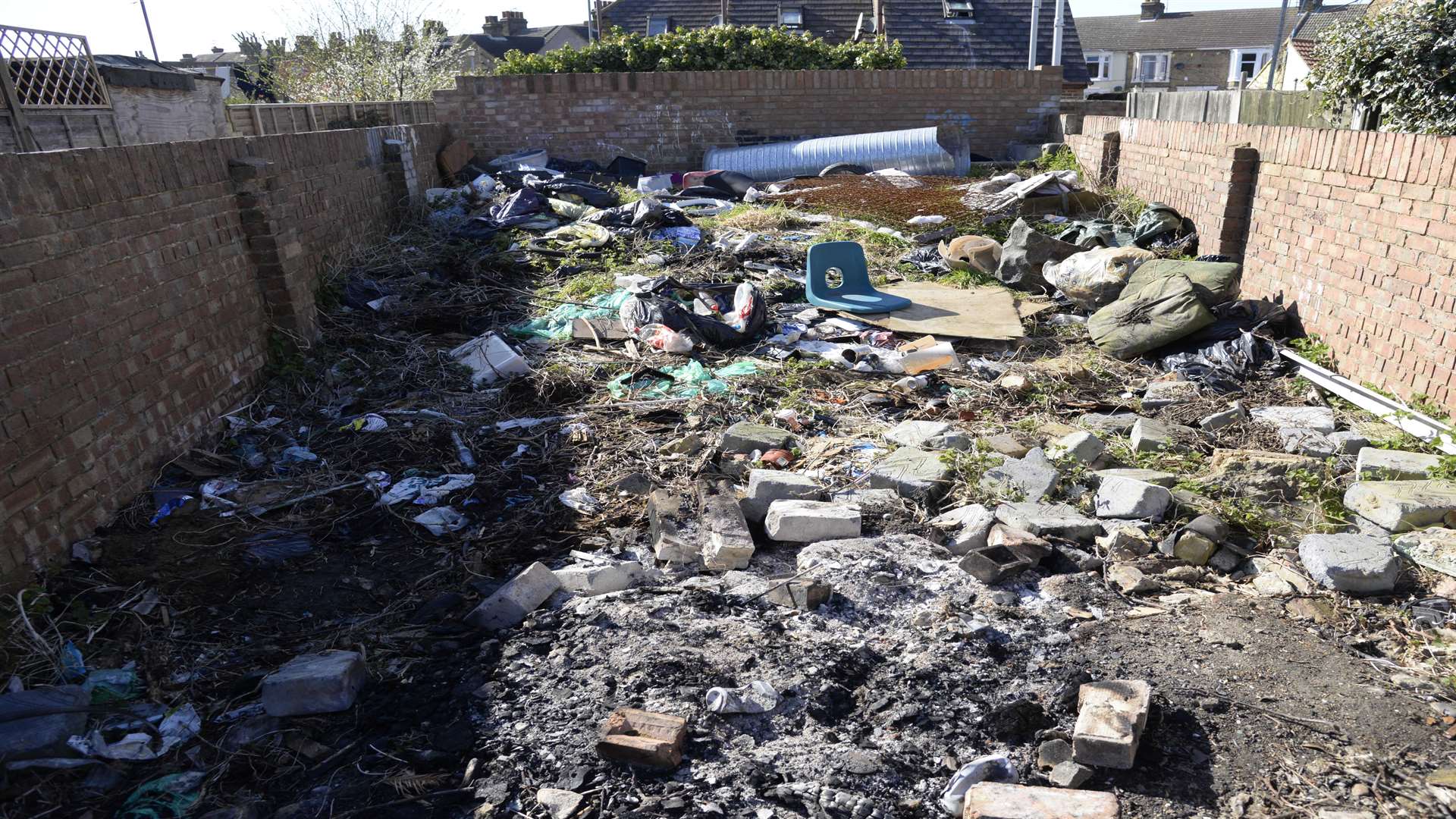 Rubbish dumped in the alley behind homes in Unity Street, Sheerness, may contain asbestos according to residents. Picture: Chris Davey