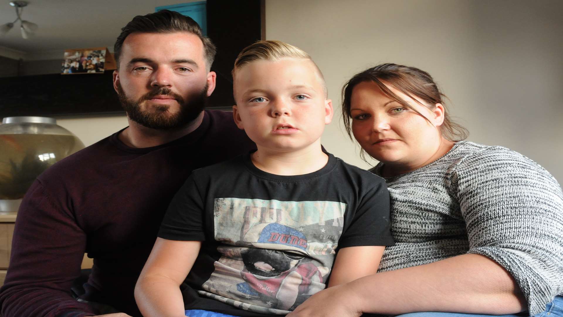 Bobby Downing-Dono, 9, was bitten at school. Pictured with mum and dad Laura and Nick. Picture: Steve Crispe