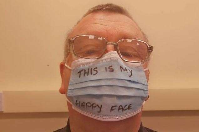 Lee Ewart has written 'this is my happy face' on his mask before heading in to Sheerness