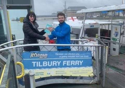 Mary Davies on the ferry from Gravesend to Tilbury presenting the book to Jack, the Master of the Ferry on that day