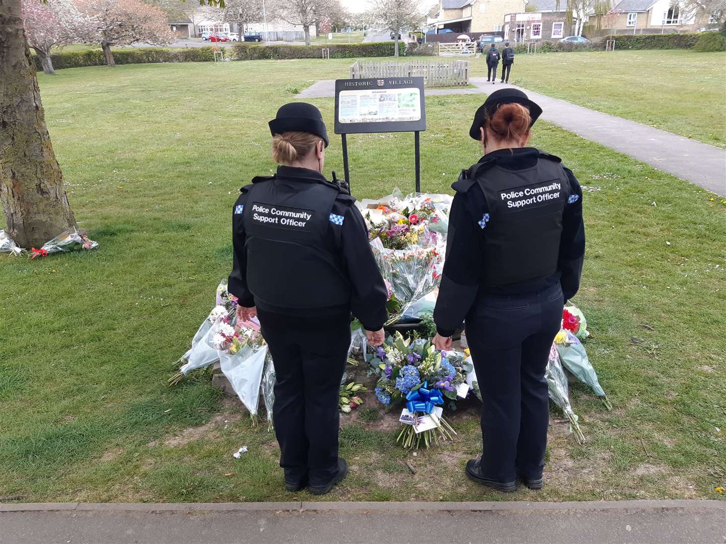 Two women PCSOs stop at the floral tributes to Julia James in Aylesham three days after her death. Picture: Sam Lennon
