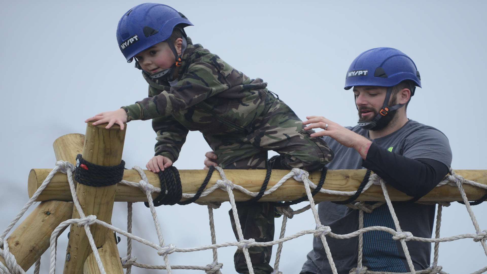 Harry Tilbury, six, helped over the new Deal assault course by his dad James.