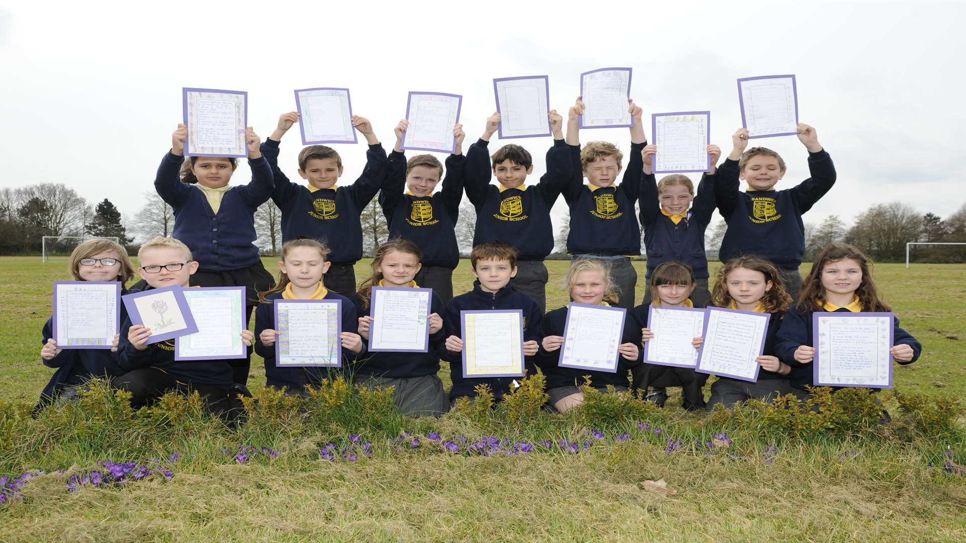 Class 4C at Sandwich Junior School hold up their poems