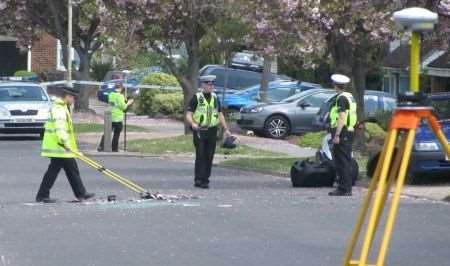 Police officers clear debris following Saturday morning's accident in Beaconsfield Road