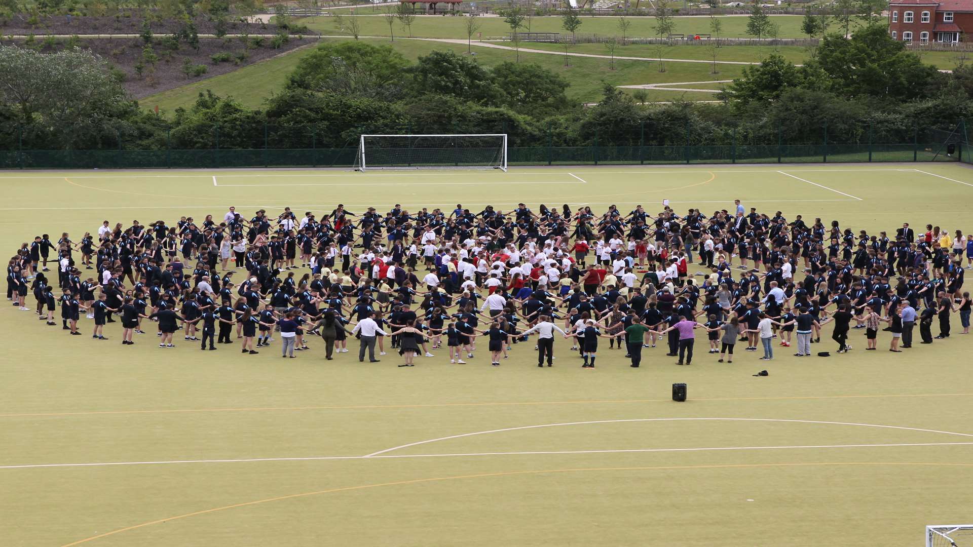 600 staff and students from The Ebbsfleet Academy and other schools on a mission to break a Guinness World Record by forming the longest ever human chain to fit through a hula hoop at Ebbsfleet Academy.