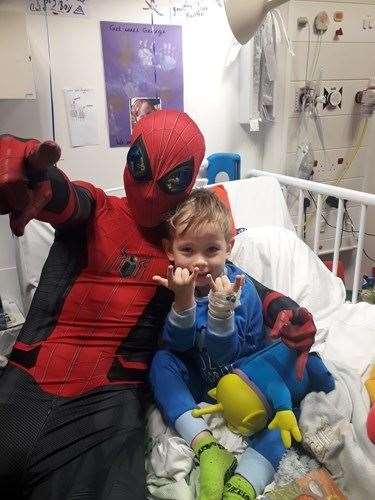 Young George gets a special visit from Medway Spidey in hospital and the two played games, coloured and had fun on the ward.