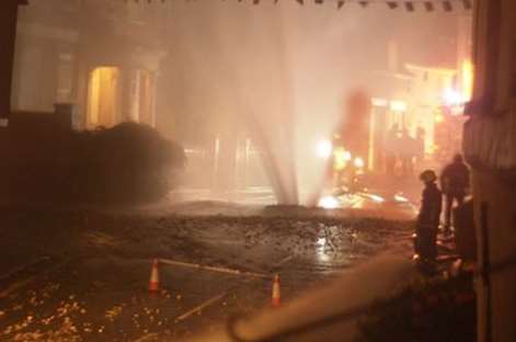 Water gushes from the street after the explosion at Charing. Picture: Charing Post Office https://www.facebook.com/CharingPostOffice