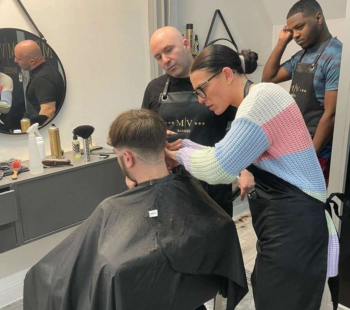 Students undertake a five week course to learn the basics of cutting hair