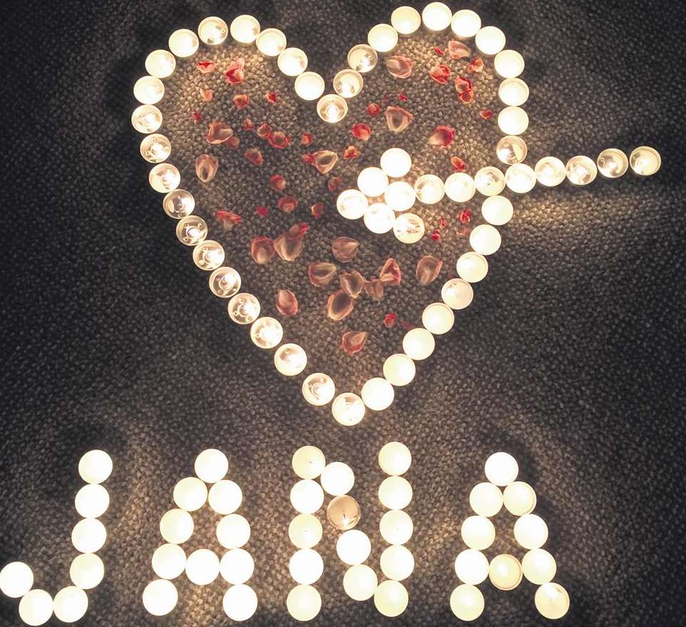 Tealights spelt out Jana's name under a heart filled with petals